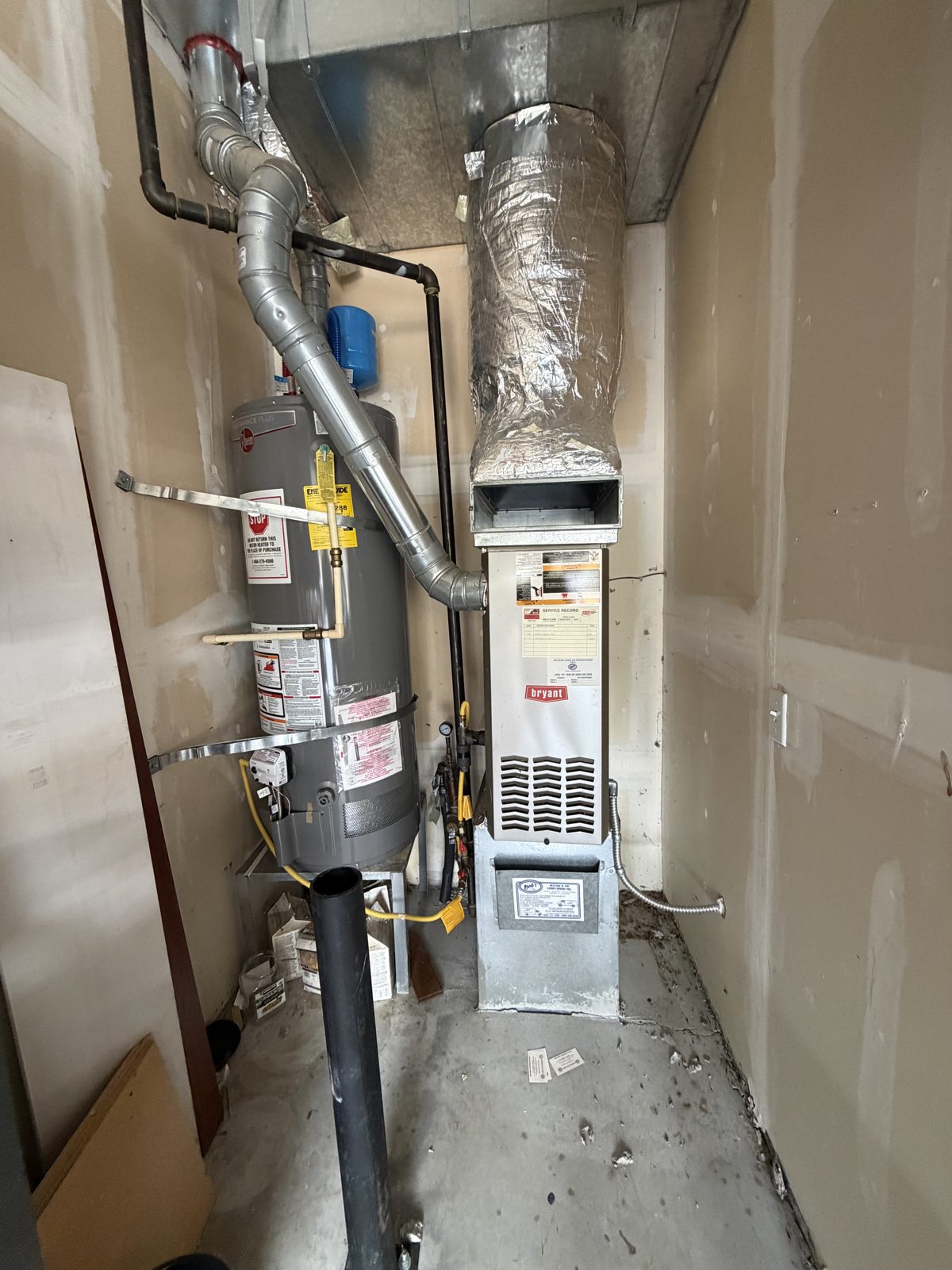 New gas furnace and water heater installed in a utility closet