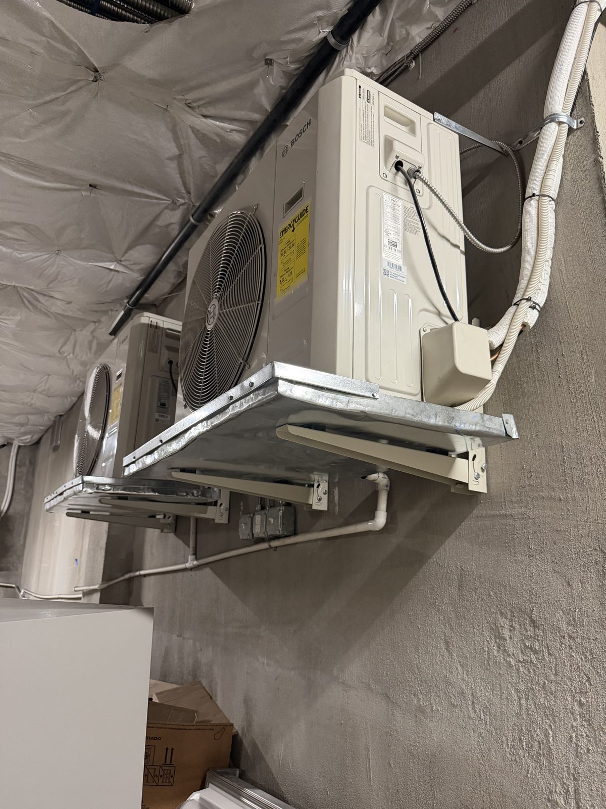 Mini-split condenser mounted on a bracket with a clean line-set run